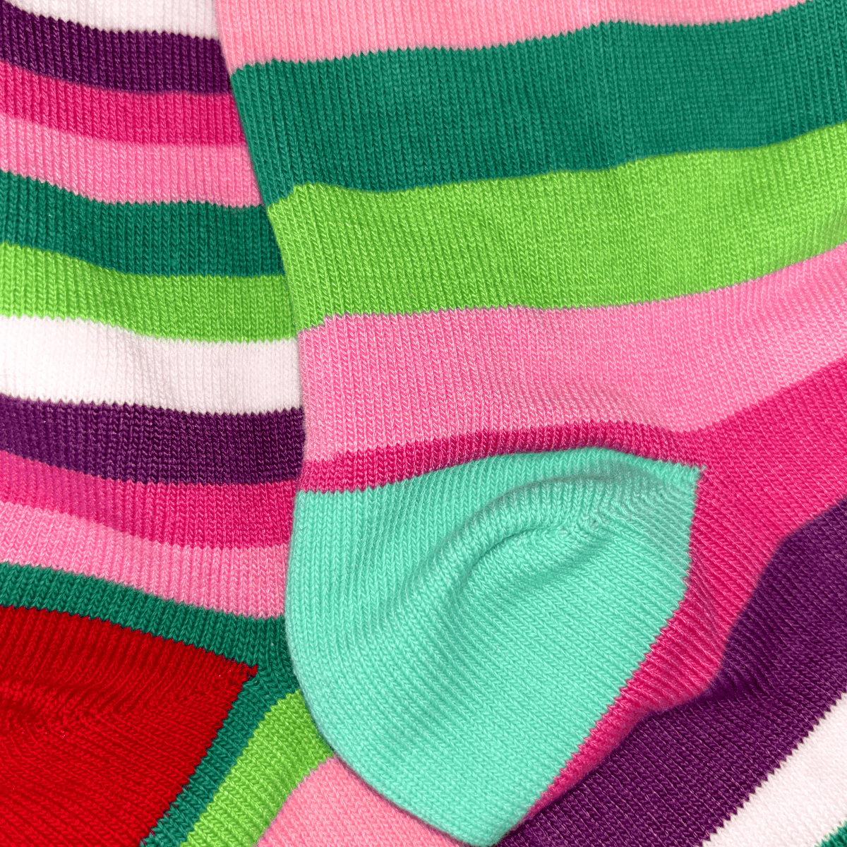 Colorful striped socks with green, pink, and purple patterns.