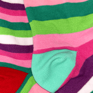 Colorful striped socks with green, pink, and purple patterns.