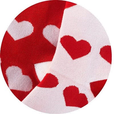 Red and white socks with heart patterns on a white background