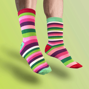 


Colorful striped socks on a person against a green background